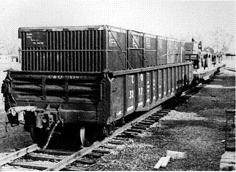 Black and white photo of Transporter Containers being moved by rail.